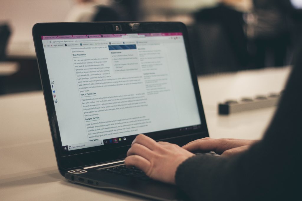 person typing on laptop computer