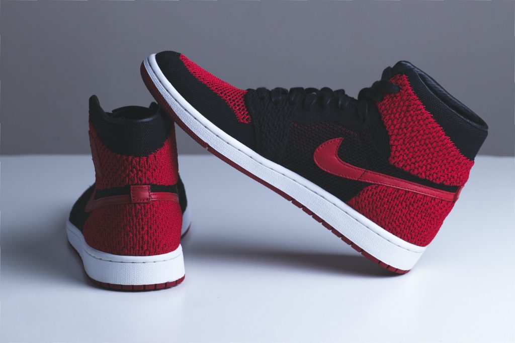 pair of red and black Nike sneakers